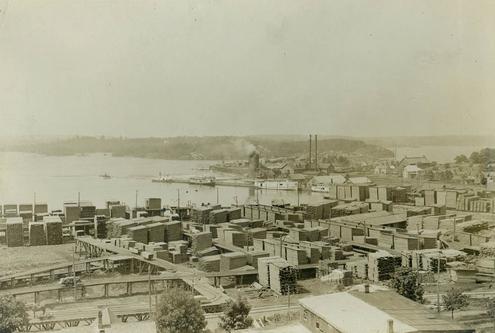 A view of the Conger Mill and lumber yards at the mouth of the Seguin River. Notice the beehive burner at centre, which was used to burn the leftover sawdust. 